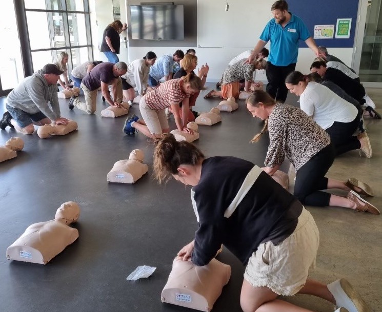 Results First Aid trainer guiding participants through hands-on CPR training